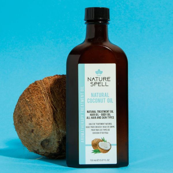 Nature Spell Coconut Oil Hair and Body Oil 150ML bottle showing the clear liquid inside.